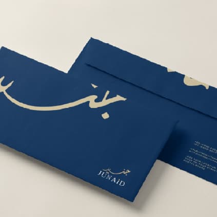 Navy Junaid Perfumes envelopes embossed with Arabic calligraphy