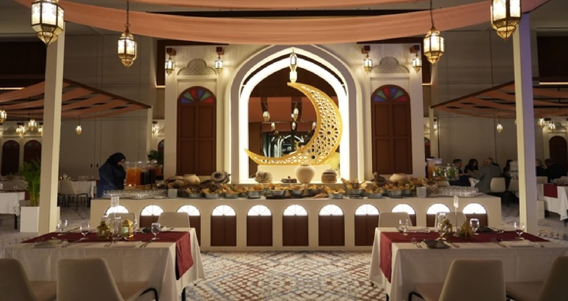 A Ramadan tent dining hall beneath a golden crescent at Sheraton Bahrain Hotel